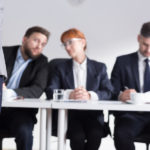 Shot of three recruiters and a job applicant keeping her fingers crossed behind her back