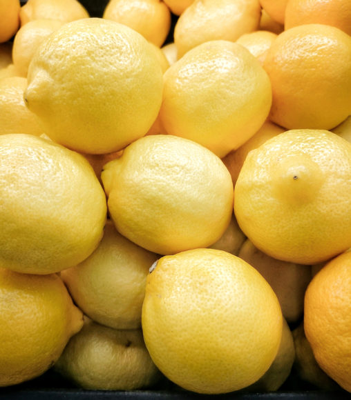 Yellow lemons in the supermarket/ Close up of yellow lemons. Food background (lemons, fruit, juicy)