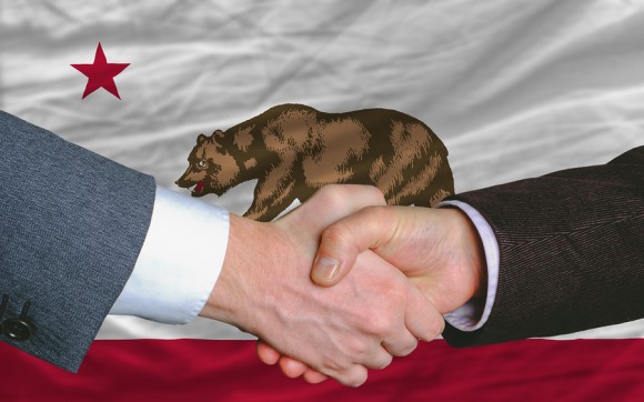 in front of american state flag of california two businessmen ha