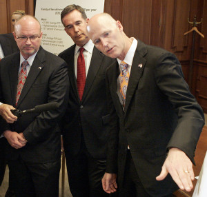 From left, insurance commissioner Kevin McCarty, CFO Jeff Atwater and Gov. Rick Scott. (AP Photo/Steve Cannon)