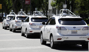 A row of Google self-driving Lexus cars at a Google event outside the Computer History Museum in Mountain View, Calif. Of the nearly 50 self-driving cars rolling around California roads and highways, four have gotten into accidents since September, 2014.  (AP Photo/Eric Risberg, File)