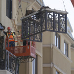 Workers remove part of a balcony that collapsed at the Library Gardens apartment complex in Berkeley, Calif., Tuesday, (AP Photo/Jeff Chiu)