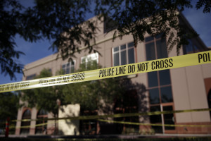 Yellow police tape is strung in front of the Inland Regional Center, site of mass shooting on Monday, Dec. 7, 2015 in San Bernardino, Calif. (AP Photo/Jae C. Hong)