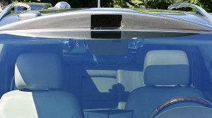 An Infrared sensor is seen above the windshield and two cameras are also seen beside the rear-view mirror of this Cadillac SRX that was modified by Carnegie Mellon University parked in a lot in Cranberry, Pa., Butler County, on Wednesday, Sept. 4, 2013. U.S. Rep. Bill Shuster, and Barry Schoch, secretary of the Pennsylvania Department of Transportation, then rode in the self-driven car that went along local roads and highways operated by a computer that used these and other inputs from radars, laser rangefinders, and infrared cameras as it made a 33-mile trip to the Pittsburgh International Airport. A Carnegie Mellon engineer was in the driver's seat as a safety precaution. (AP Photo/Keith Srakocic)