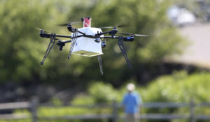 A drone aircraft with a payload of simulated blood, and other medical samples flies during a ship-to-shore delivery simulation Wednesday, June 22, 2016, in Lower Township, N.J. How to distribute lifesaving supplies quickly and safely after a natural disaster has long been a puzzle for responders. Now, drones might be the lifesaver. That idea was put to the test this week on the New Jersey coast as a drone delivery conducted test flights to help determine whether drones can be used to carry human medical samples to and from areas during major natural disasters. (AP Photo/Mel Evans)