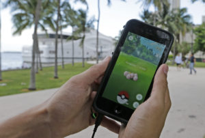 Exeggcute, a Pokemon, is found by a Pokemon Go player, Tuesday, July 12, 2016, at Bayfront Park in downtown Miami. The "Pokemon Go" craze has sent legions of players hiking around cities and battling with "pocket monsters" on their smartphones. It marks a turning point for augmented reality, or technology that superimposes a digital facade on the real world. (AP Photo/Alan Diaz)