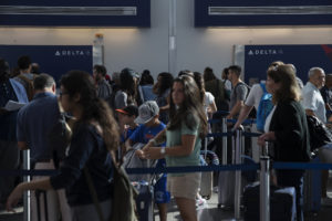 Delta passengers make their way through Terminal C at LaGuardia Airport in Queens, New York, Thursday August 8, 2016. Due to a computer malfunction, Delta's global operations were grounded on Monday morning, with delayed flights resuming around 8:30 AM. Photograph: Victor J. Blue