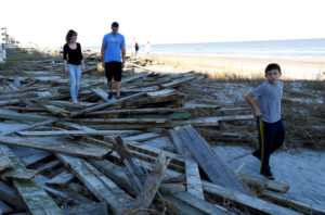 People look around the debris of the pier damaged by Hurricane Matthew in Surfside Beach, South Carolina, U.S. October 9, 2016. REUTERS/Randall Hill