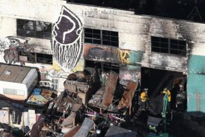 Firefighters work inside the burned warehouse following the fatal fire in the Fruitvale district of Oakland, California, U.S. December 4, 2016. REUTERS/Lucy Nicholson