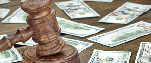 Financial Crime or Fraud or Auction Concept Image With Judges Gavel or Auction Hammer And Money Stack On The Background, Close Up