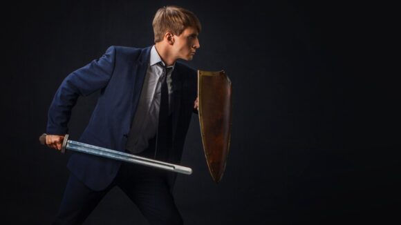 09 07 02 businessperson with shield -