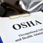 Pile of documents with Occupational Safety and Health Administration OSHA.