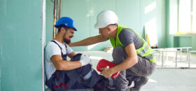 Construction worker accident with a construction worker. First aid for injury at work.