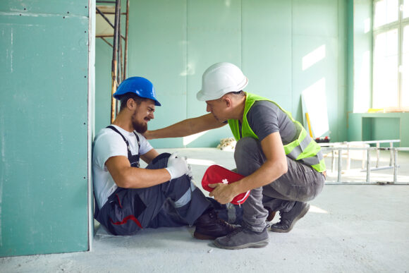 Construction worker accident with a construction worker. First aid for injury at work.