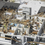 In this aerial view captured from a helicopter, the destruction left in the wake of Hurricane Ian is shown on Saturday, Oct. 8, 2022, on Sanibel Island, Florida. Sanibel Island and Fort Myers Beach sustained severe damage from the Category 4 hurricane, which caused extensive damage to the southwest portion of Florida. (AP Photo/Alex Menendez)