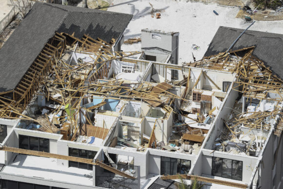 In this aerial view captured from a helicopter, the destruction left in the wake of Hurricane Ian is shown on Saturday, Oct. 8, 2022, on Sanibel Island, Florida. Sanibel Island and Fort Myers Beach sustained severe damage from the Category 4 hurricane, which caused extensive damage to the southwest portion of Florida. (AP Photo/Alex Menendez)