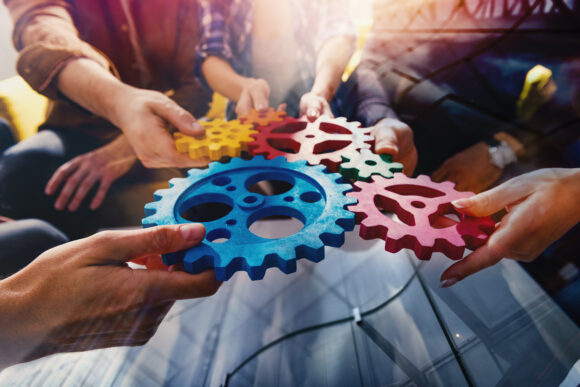 Business team connect pieces of gears like a teamwork and partners