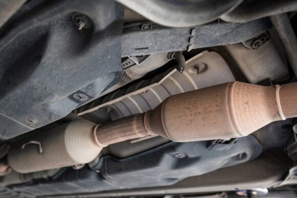 Close-up of catalytic converter in automobile exhaust system.