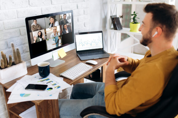 Communication by video conference. Close up photo of computer screen with people. Business colleagues discuss about economic trends by video conference from home. Distant work