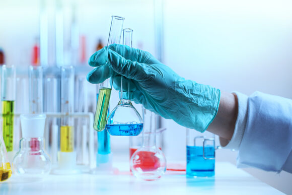 The laboratory assistant holding test tube
