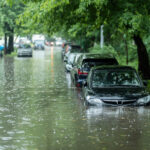 Flooded cars on the street of the city. Street after heavy rain. Water could enter the engine, transmission parts or other places. Disaster Motor Vehicle Insurance Claim Themed. Severe weather concept