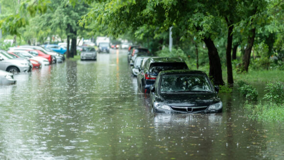 Flooded cars on the street of the city. Street after heavy rain. Water could enter the engine, transmission parts or other places. Disaster Motor Vehicle Insurance Claim Themed. Severe weather concept