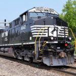Naperville, Illinois, USA. Led by a freshly painted off-road Norfolk Southern Railway locomotive a Burlington Northern Santa Fe freight train passes through northeastern Illinois on its journey to Chicago. The highly active stretch of tracks, shared with Metra, Chicago's commuter railroad network, is often called the 'Racetrack' due to its heavy train volume. The freight moved over this line connects Chicago with a wide variety of southwestern, western and northwestern destinations in the United States including the country's West Coast.