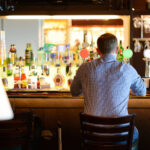 Lonely man in shirt sitting at bar desk