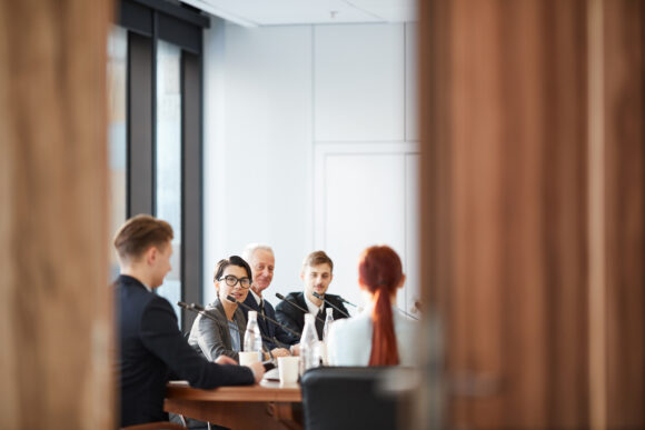 View of business meeting in conference room through open door, copy space