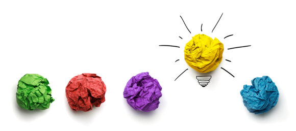 Great idea, standing out of the crowd concept. Crumpled paper as symbol of a light bulb, idea isolated on white background