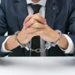Businessman with handcuffs