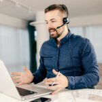 A customer support agent working online form home and helping clients.