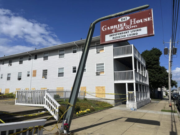 Boards cover the windows of the Gabriel House assisted living facility, where a fire on Sunday killed several people, Tuesday, July 15, 2025 in Fall River, Mass. (AP Photo/Kimberlee Kruesi)
