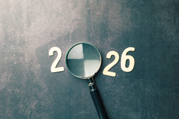 Conceptual image representing future outlook, year 2026 analysis, planning ahead, using magnifying glass to inspect or predict next year