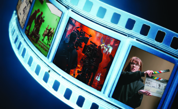Curving illuminated film strip featuring scenes from movie production, including a film set, camera crew, and director holding a clapperboard against a dark blue background.