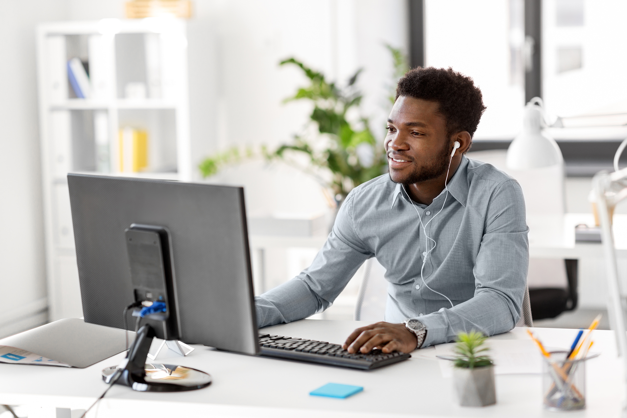 businessman with earphones and computer at office