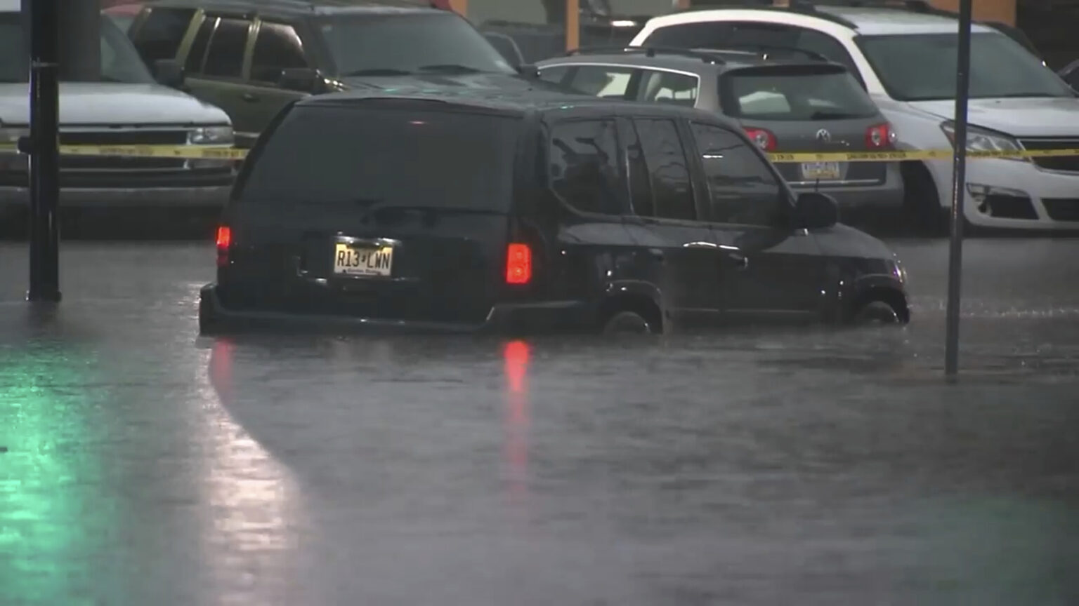 This image made from video shows cars submerged in floodwaters in Rahway, NJ., on July 14, 2025.(WABC-TV via AP)