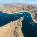 High angle satellite view of the Strait of Hormuz showing the strategic maritime chokepoint between Iran and Oman for global trade and logistics