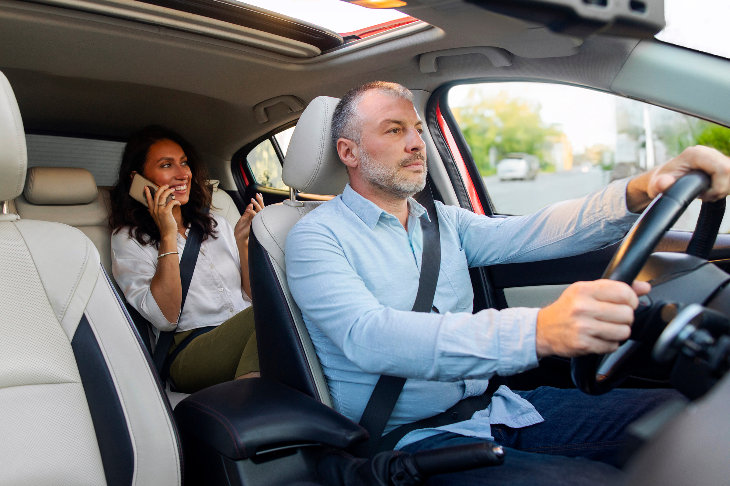 Middle aged man taxi driver riding car while woman passenger talking on cellphone sitting on backseat. Taxi service concept