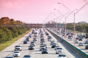 Traffic moves steadily along I-95 north and south in a hot sunny