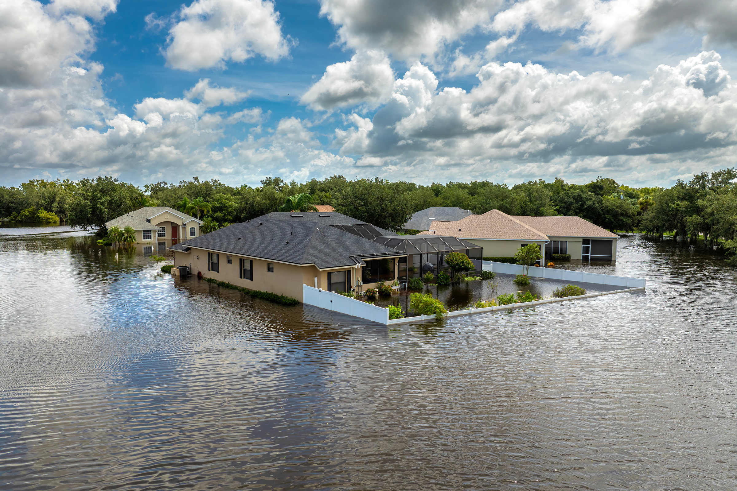 Hurricane Debby tropical rainstorm flooded residential homes in suburban community in Sarasota, Florida. Aftermath of natural disaster.