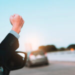 image of man in a celebrating success with a fist pump while dri