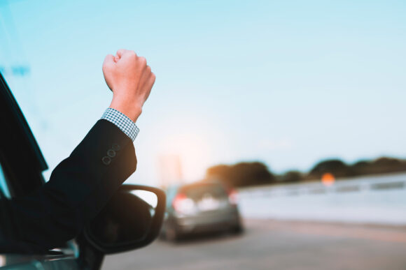 image of man in a celebrating success with a fist pump while dri