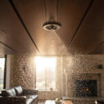 Automatic fire sprinkler system spraying water in modern luxury living room for safety and protection.