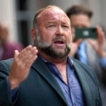 Right-wing conspiracy theorist Alex Jones speaks to the media after arriving at the federal courthouse for a hearing in front of a bankruptcy judge in Houston, June 14, 2024. (AP Photo/David J. Phillip, File)