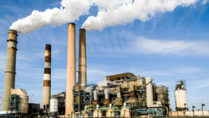Large Industrial Fossil Fuel Power Plant with Smokestacks Release