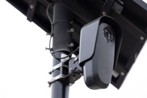 Fullerton, California, USA - August 14, 2026: An AI Flock camera surveils a city street for car license plates on a dark cloudy day.