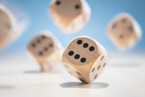 Throwing and rolling many wooden dice on a blue background
