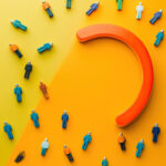 Magnet attracting people traffic on color background, top view