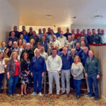 Shepherd Insurance employees pose for a large group photo on a staircase